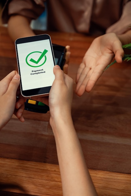 A hand holding a smartphone displaying a credit score app with a positive reading and a green checkmark, emphasizing the benefits of the Cadastro Positivo.