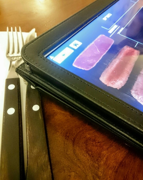 Close-up of a smartphone screen showing the FGTS app's main menu with options like 