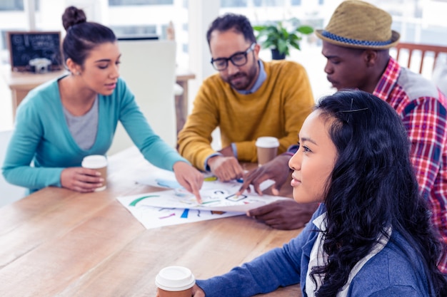 A meeting table with people participating in a discussion related to community projects. Emphasizing collaborative decision-making.