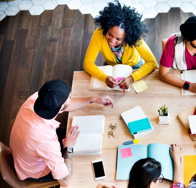 A brainstorming session featuring diverse community members gathered around a table, scribbling ideas on sticky notes and discussing plans for a local event, emphasizing collaborative decision-making and community involvement.