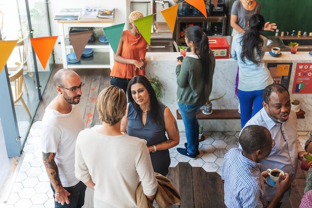 A group of parents and teachers gathered in a community center, participating in a workshop on early childhood education strategies, with notebooks, handouts, and engaged expressions. The scene should evoke a sense of learning and collaboration.