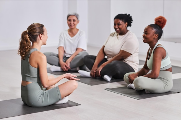 Women participating in a yoga class in a community center, promoting health, wellness, and stress relief, contributing to their overall empowerment.