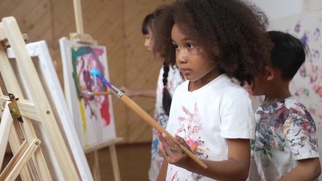 Children from diverse backgrounds participating in a collaborative mural painting workshop in a community center.
