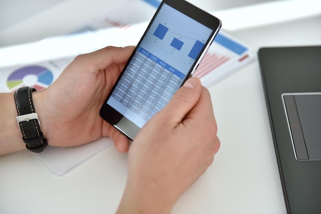 A close-up of a smartphone screen displaying the e-carteira de trabalho application, highlighting the user's personal data and employment history.