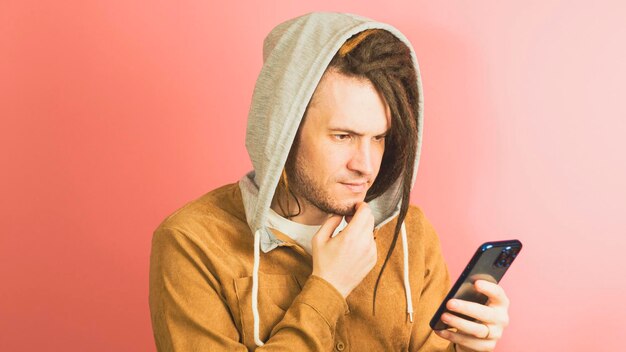 An image of a person with a worried expression looking at their phone, which displays a suspicious message or notification related to a scam.