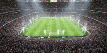 Vibrant stadium with cheering fans and national flags during a major sporting event.