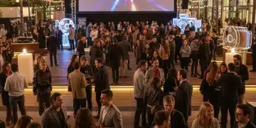 Filmmakers networking at a bustling U.S. film festival, vibrant atmosphere